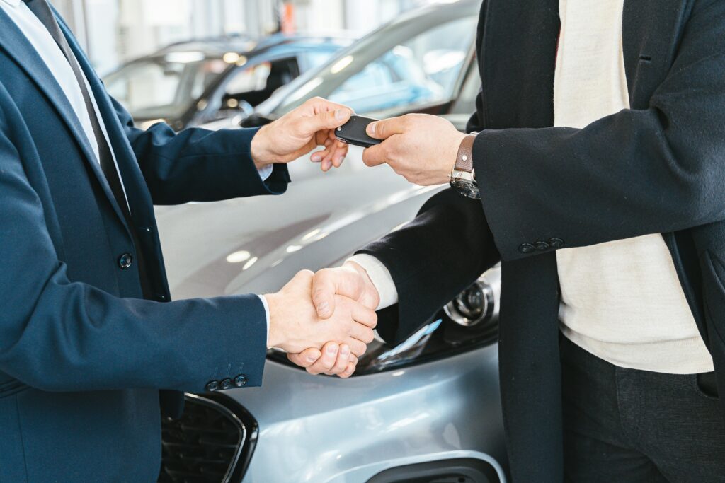 Dealership team discussing warranty product strategies, showcasing a case study on achieving a 50% placement rate with effective F&I sales techniques.