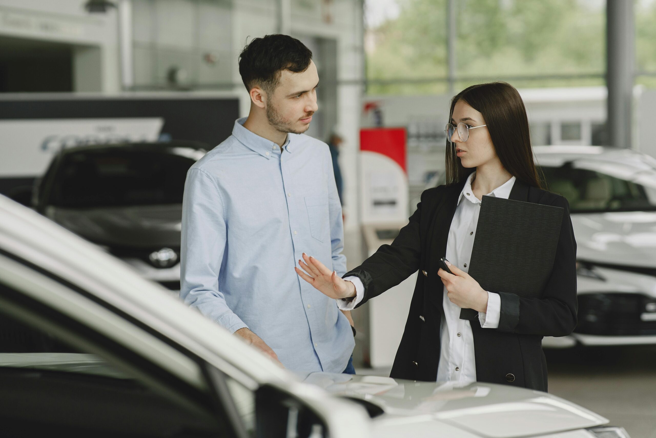 F&I dealer consulting with a customer, highlighting the importance of a consultative approach in automotive sales for building trust and driving success.