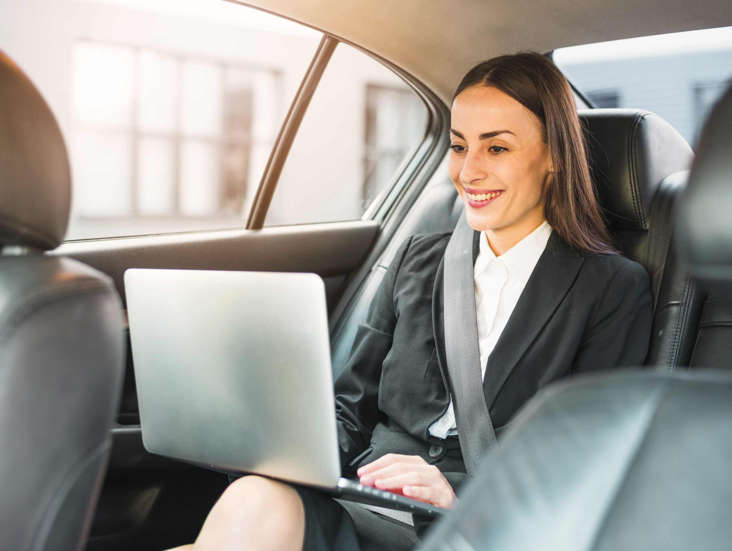 A finance and insurance (F&I) professional using advanced F&I prospecting tools on a laptop, analyzing data to enhance customer outreach and dealership sales.