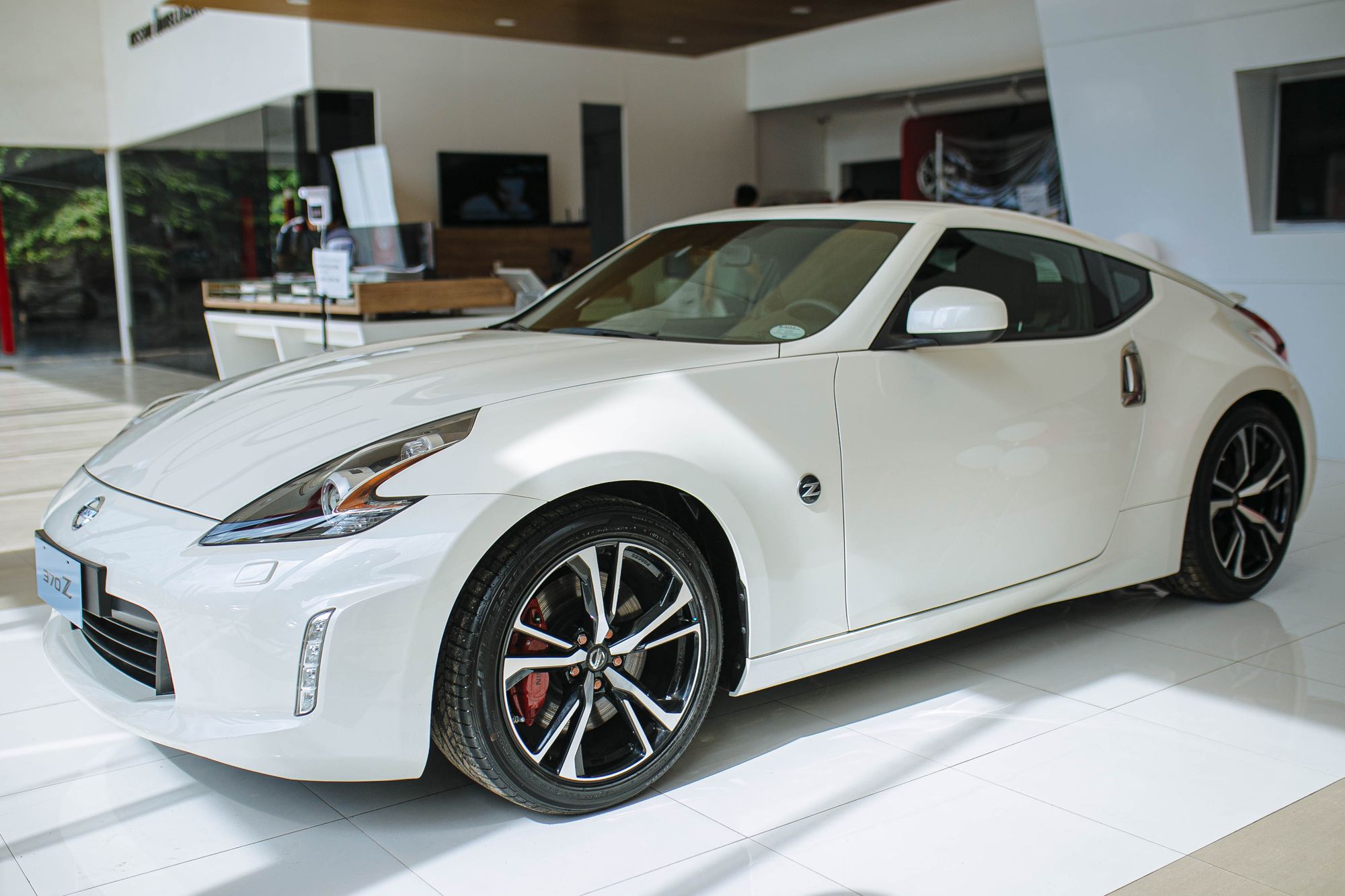 White sports car parked in a dealership showroom