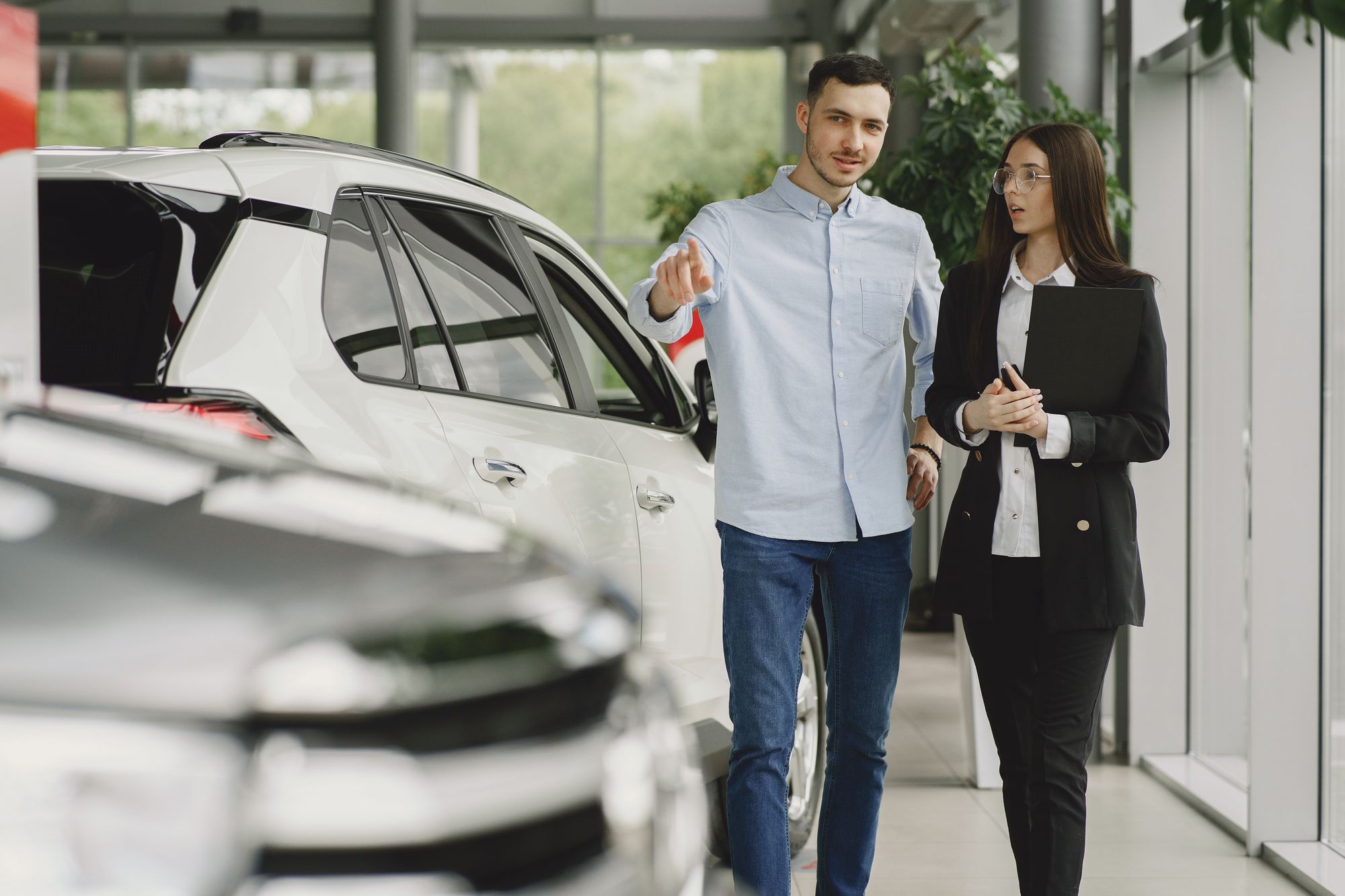Dealership employee working with a client on a vehicle sale